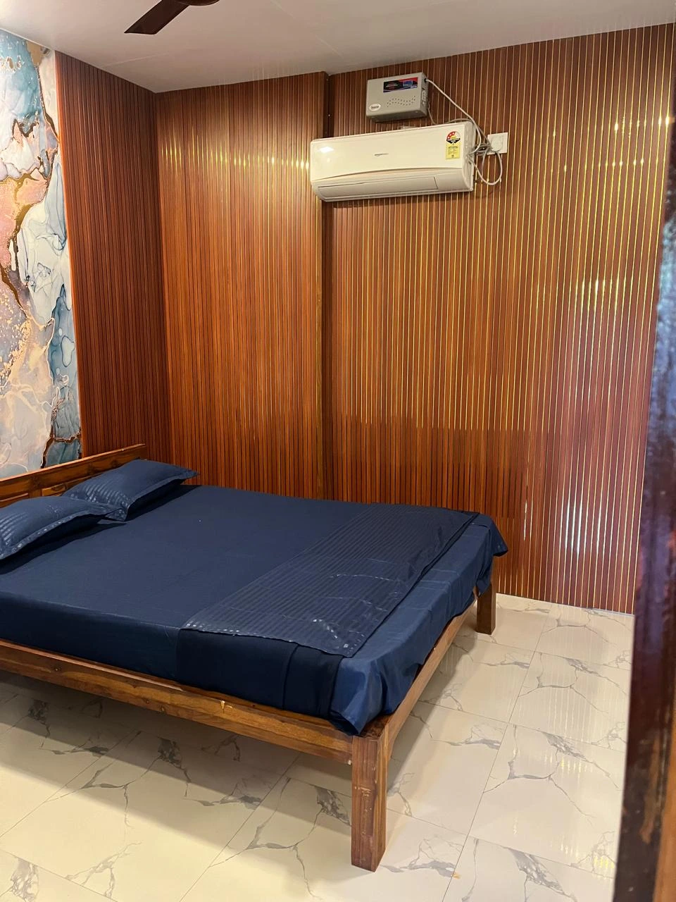Polished room at Dolphin House Beach Resort used to suggest an overnight extension for travelers who convert their one-day Alibaug trip into a longer stay